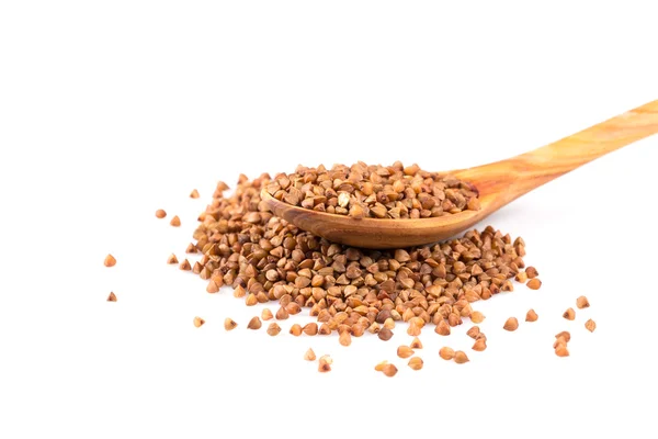 Uncooked buckwheat on wooden spoon — Stock Photo, Image