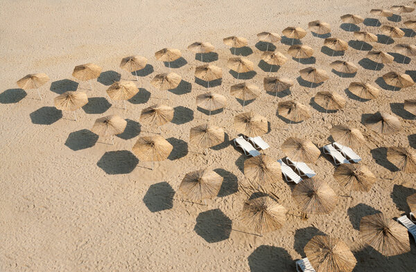 Beautiful beach on the beach with sun loungers and parasols