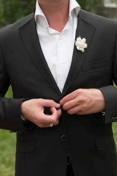 Groom botões jaqueta preta com flor branca — Fotografia de Stock