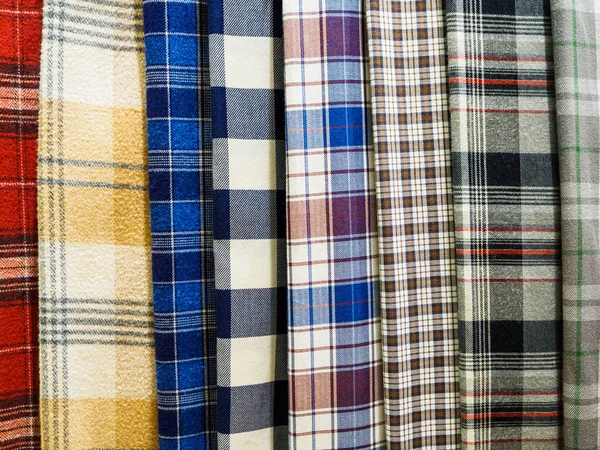 A large selection of bright plaid fabrics in the fabric store. Close-up of cellular tissue samples. Large collection of beautiful fabrics at the factory or in the store.