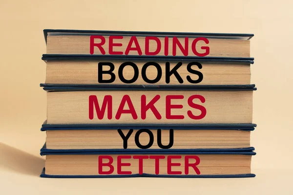 Reading books makes you better-text on a stack of books. The concept of learning new knowledge, self-improvement