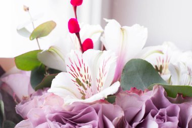 Bir buket Alstroemeria ve mor güller. Taze, yemyeşil renkli çiçekler.