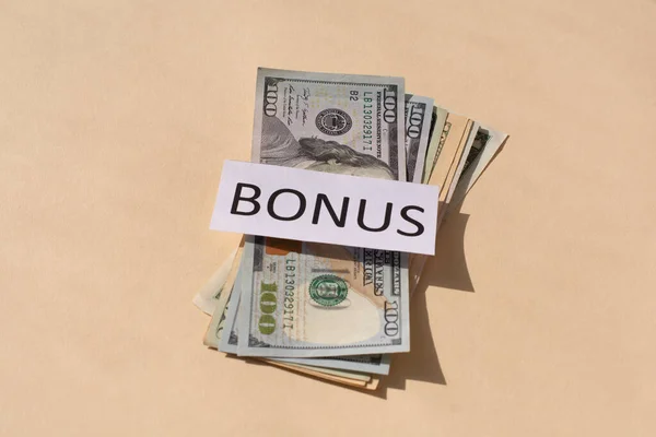 Cash Dollars money and the word BONUS . Concept of bonus