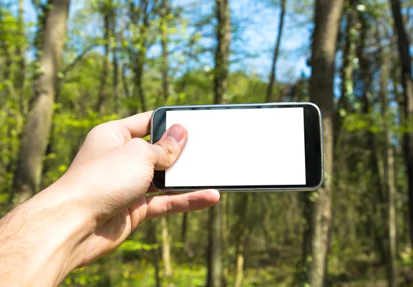 Trzymając telefon komórkowy — Zdjęcie stockowe