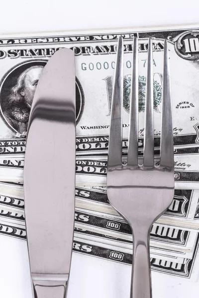 Dollar Banknote under Knife and Fork Stock Image