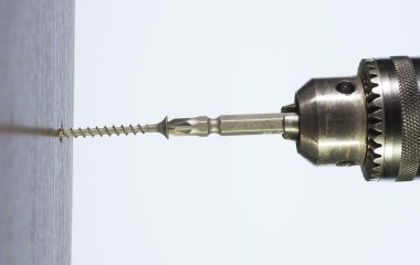 tool screwdriver and a screw in his hand