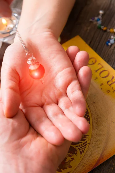 Palm reading with pendulum — Stock Photo, Image