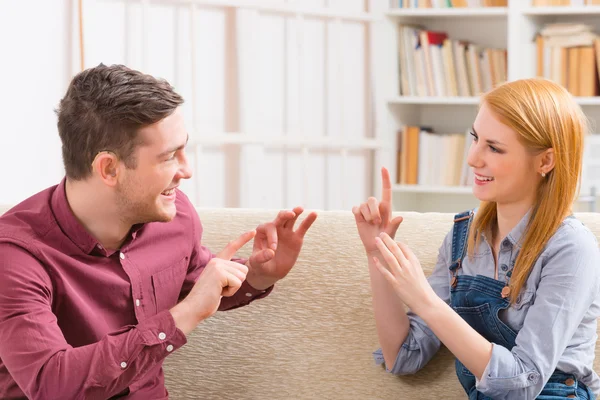 Deaf man with his girlfriend using sign language — Stock Photo, Image