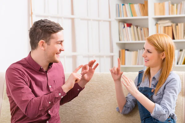 Deaf man with his girlfriend using sign language — Stock Photo, Image