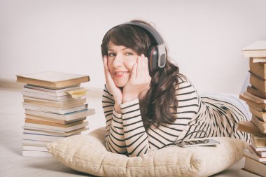Woman listening an audiobook clipart