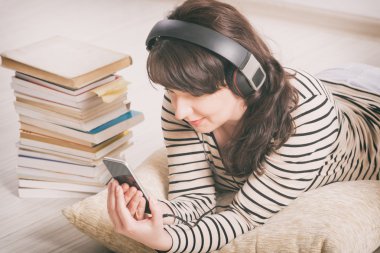 Woman listening an audiobook clipart