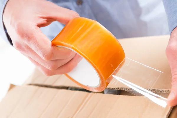 Transparent tape in hands — Stock Photo, Image