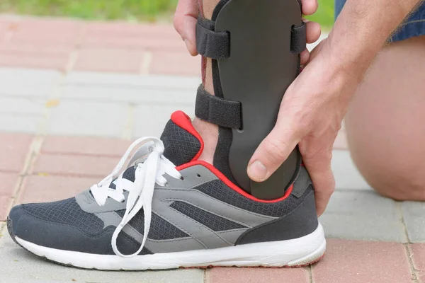 Man Athletic Sneakers Wearing Ankle Orthosis Brace — Stock Photo, Image