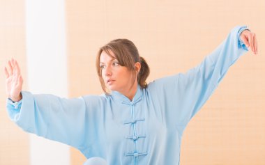 Woman doing qi gong tai chi exercise clipart