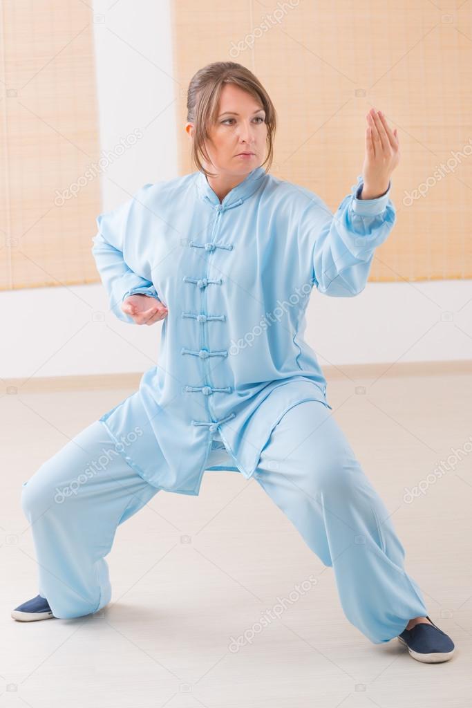 Woman doing qi gong tai chi exercise