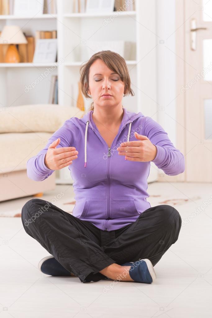 Woman doing qi gong tai chi exercise