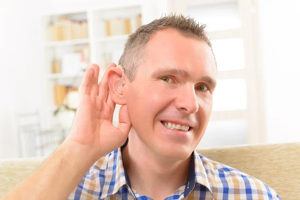 Man showing deaf aids — Stock Photo, Image