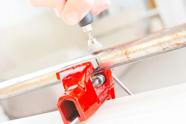 Cleaning of rusty pipe with rotary multi tool — Stock Photo, Image