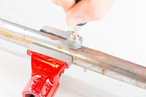 Cleaning of rusty pipe with rotary multi tool — Stock Photo, Image