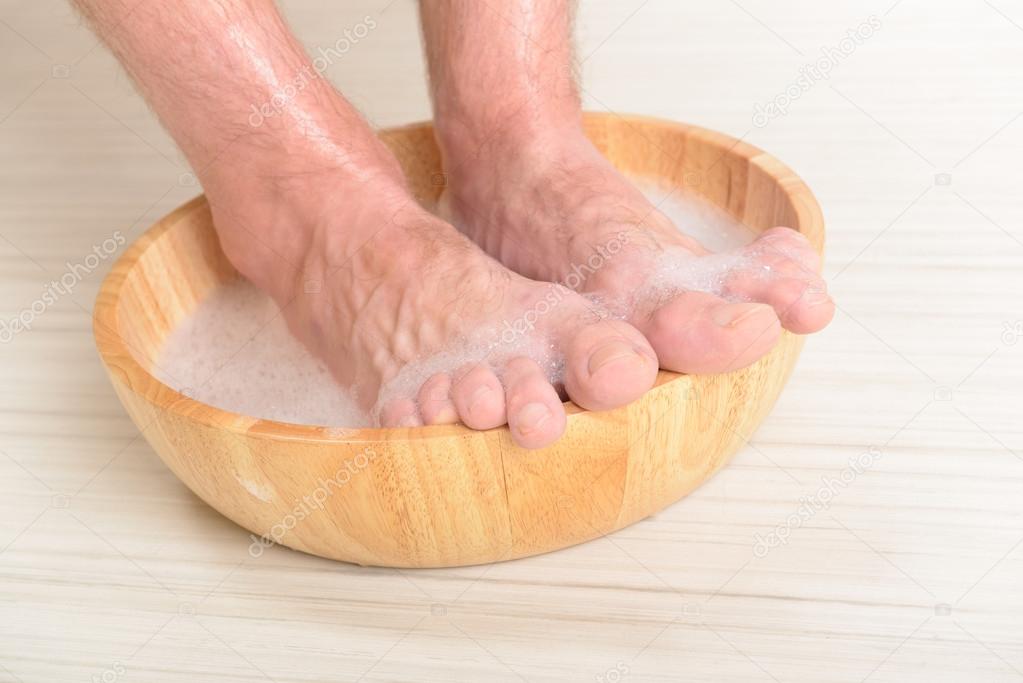 Male feets in a bowl 