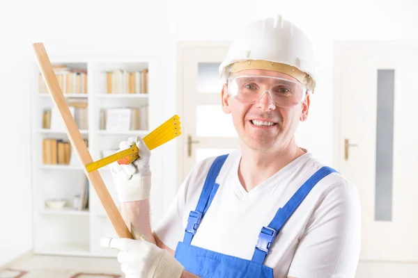 Man with ruler weraing protective suit — Stock Photo, Image