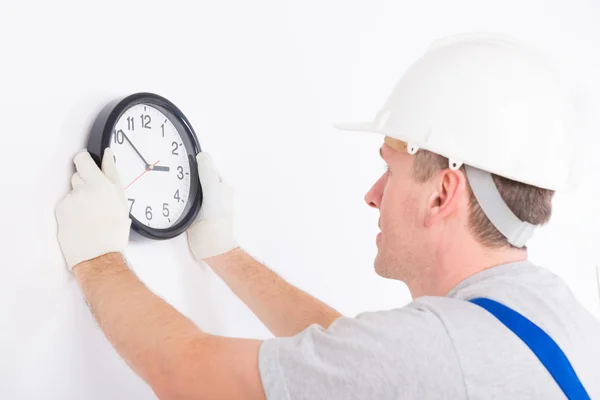 Man hanging clock — Stock Photo, Image