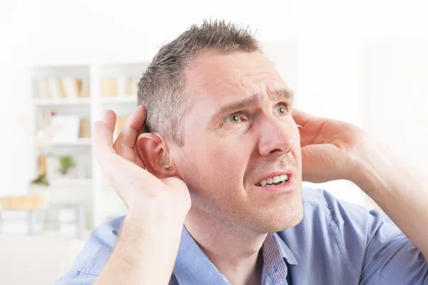 Man wearing deaf aid — Stock Photo, Image