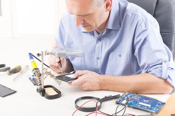 Reparación del teléfono móvil en el taller electrónico —  Fotos de Stock