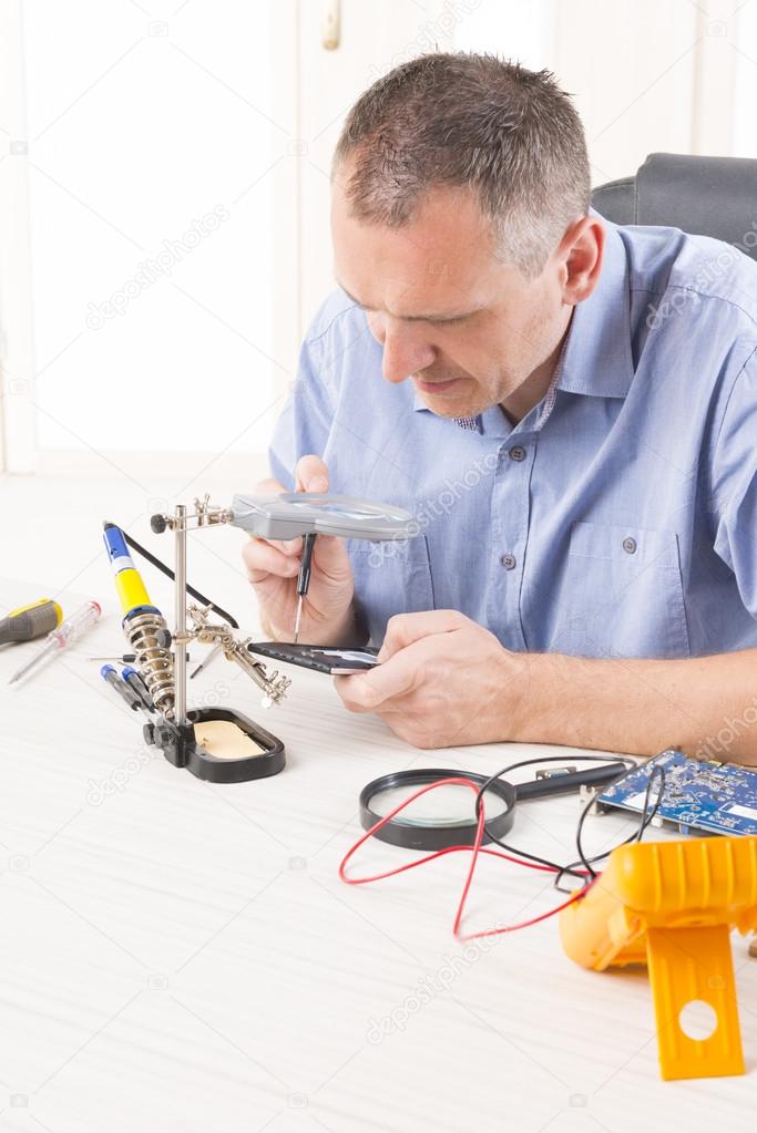 repairing mobile phone in the electronic workshop