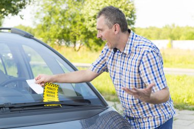Man looking on parking ticket
