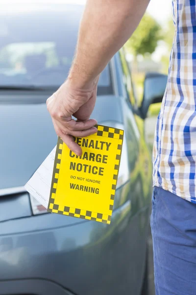 Man holding parking ticket — Stock Photo, Image