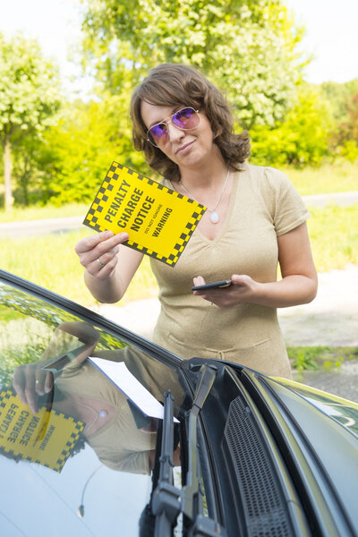 woman holding parking ticket