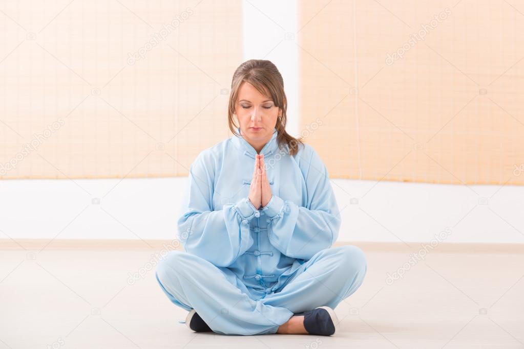 Woman doing qi gong tai chi exercise