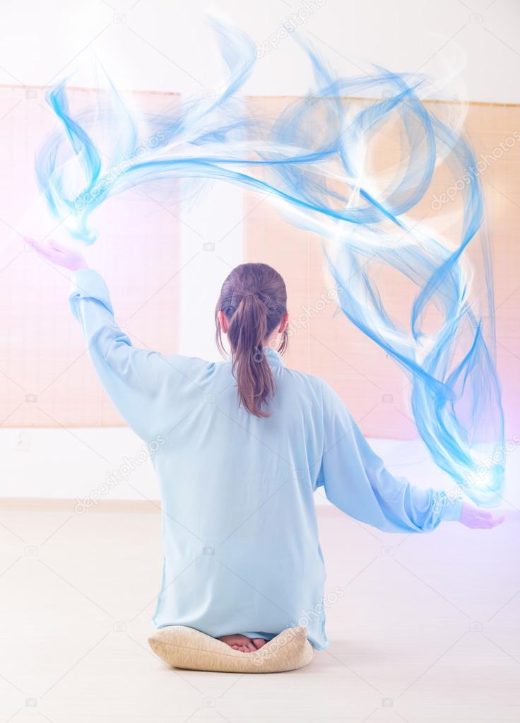 Woman doing qi gong tai chi exercise