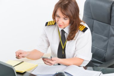 Woman airline pilot at the office clipart
