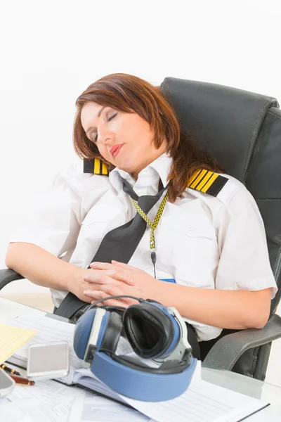 Mujer piloto de línea aérea durmiendo en la oficina — Foto de Stock