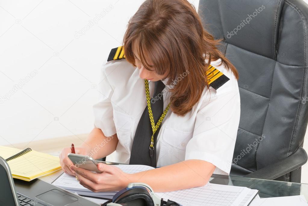 Woman airline pilot at the office