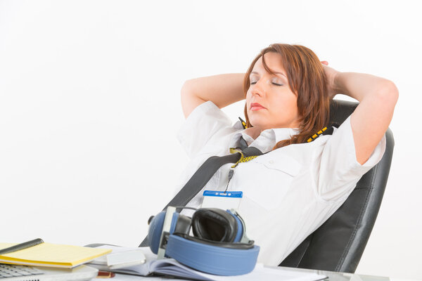 Woman airline pilot sleeping in the office