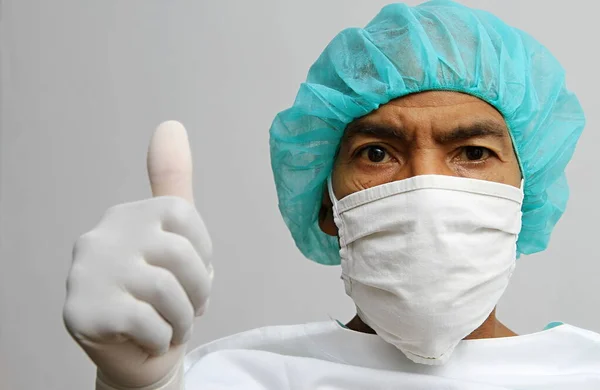 Coronavirus outbreak doctor with face mask and white gloves in hospital with white background stock photo