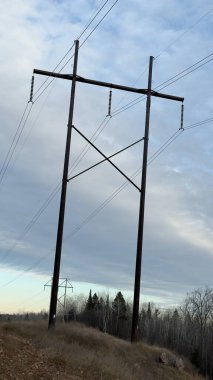 high voltage power pole in a field