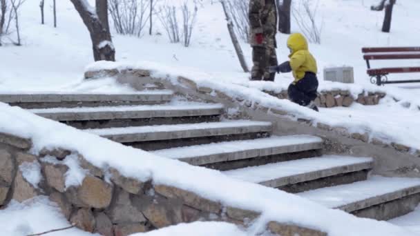 Snöfall Vinter Offentlig Park Pojke Gul Kostym Och Murverk Trappor — Stockvideo