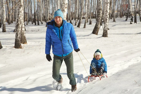 Играть отца и сына зимой на открытом воздухе — стоковое фото