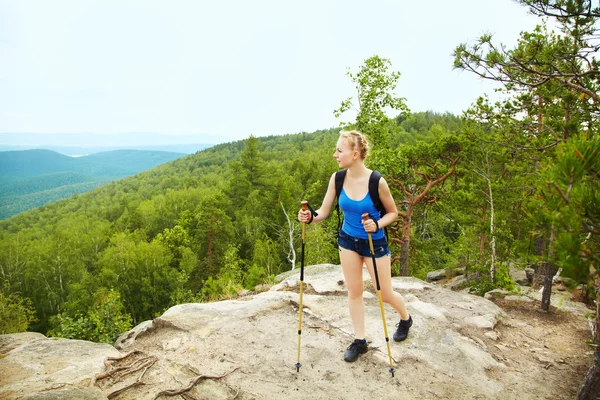 Kvinna med ryggsäck vandring i bergen — Stockfoto