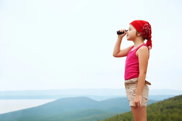 Girl with spyglass — Stock Photo, Image