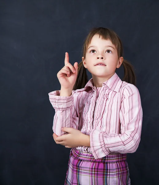 Schoolchild on blackboard background — Stock Photo, Image