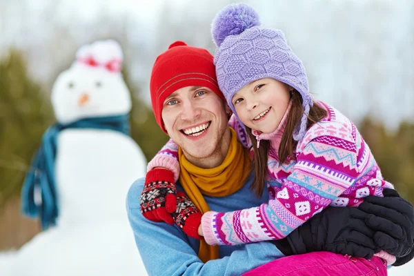 Father and daughter with snowman Royalty Free Stock Images