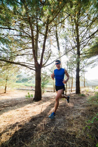 Man running in a forest outdoors — Stock Photo, Image