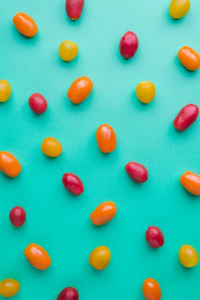 Elongated cherry tomatoes of different colors (red, yellow, and Stock Image