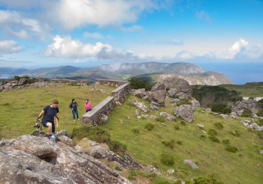 Beautiful galician landscape with tourists  clipart