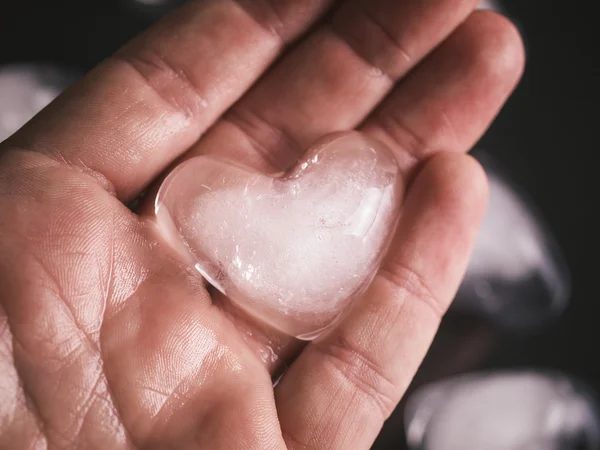 Ice heart in a hand — Stock Photo, Image